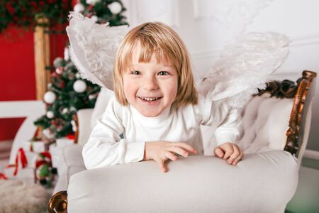 Happy little smiling child celebrates Christmas. New Year's holidays.の写真素材
