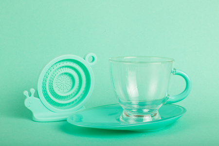 Glass cup in turquise background