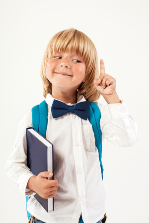 Portrait of happy schoolboy with books isolated on white background. Education, isolated. School preschoolの写真素材