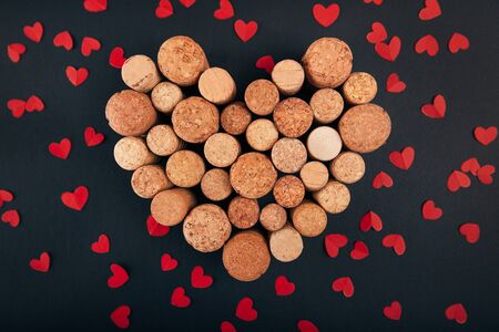 Valentine heart from wine corks on blackbackgroundの写真素材