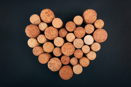 Valentine heart from wine corks on blackbackgroundの写真素材