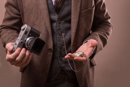 Man with retro camera in tweed vintage dressの写真素材