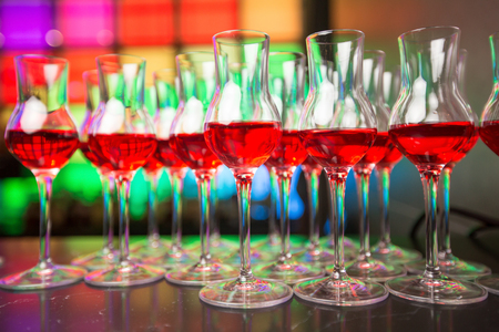 Glass dishes in color lights backgroundの写真素材