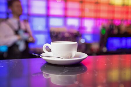 White tea cup and teapot on color lights backgroundの写真素材