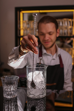 Professional bartender prepairing orange cocktailの写真素材