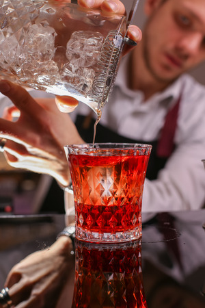 Professional bartender prepairing orange cocktailの写真素材