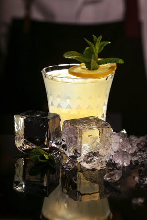 Fitzgerald alcohol cocktail on black background surface. Barmen is making Fitzgerald cocktailの写真素材