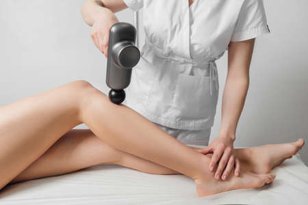 Woman getting anti-cellulite and anti-fat therapy in beauty parlourの写真素材