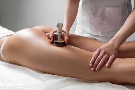 Anti-cellulite massage of the hips with the use of vacuum cansの写真素材