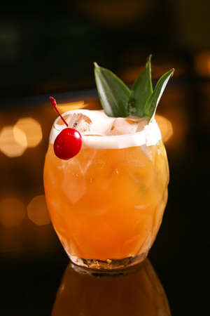 Alcohol cocktail orange drink on blur green backgroundの写真素材