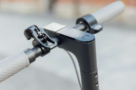 Electric scooter handle bar with smart display on grey background