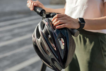 Young woman holding protection helmet for ridingの写真素材