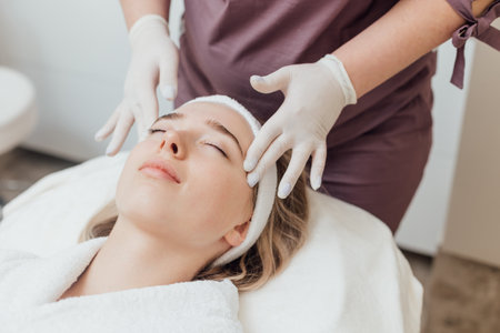 Beautician make face treatment at beauty clinicの写真素材