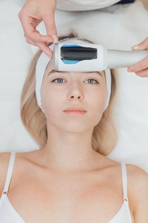 Cosmetologist uses endospheres device on a female faceの写真素材