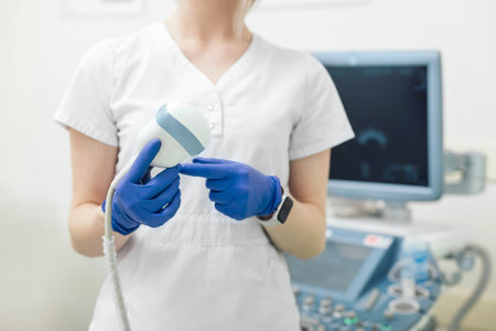 The doctor holds in his hands a transducer with a gel for ultrasound diagnostics of internal organsの写真素材
