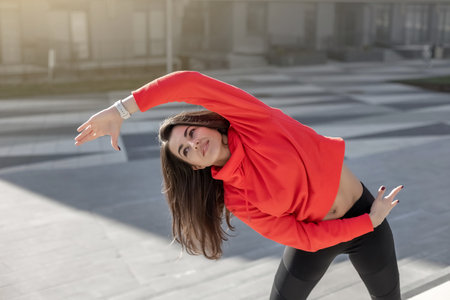 Fitness woman is fitness stretching and exercising outdoor in urban environment