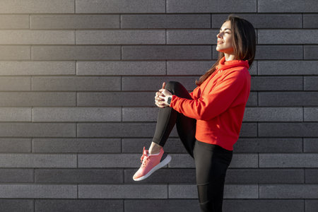 Sport woman is fitness stretching and exercising outdoor in urban environment