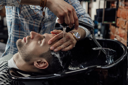 Washing a head before haircut in barbershopの写真素材
