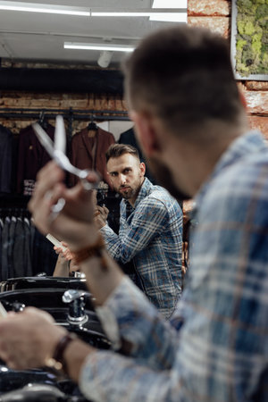 Portrait of a barber with haircut tools in barbershopの写真素材