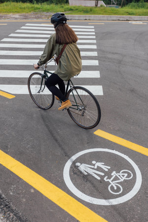 close up womans hand hold road bicycle on crosswalkの写真素材