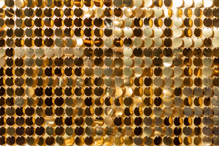 Decorative gold background with glitter confetti shapesの写真素材