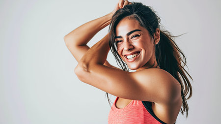 Portrait of cheerful sporty woman isolated on color backgroundの素材