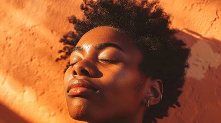 Close-up of an LGBTQ person with eyes closed, basking in golden-hour sunlightの素材