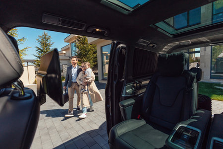 A young stylish family with their son and luggage goes to cars interior