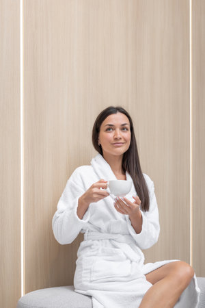 Relaxing moment with a warm beverage in a serene settingの写真素材