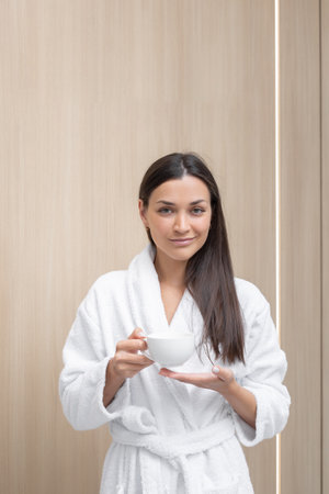 Relaxing moment with a warm beverage in a serene settingの写真素材