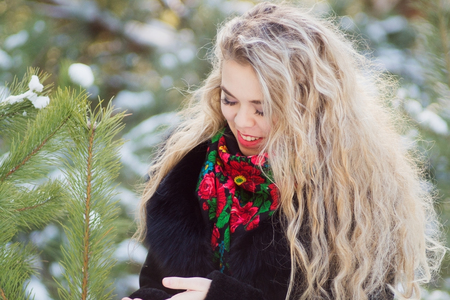 Woman walking on snowy woods cold weatherの写真素材