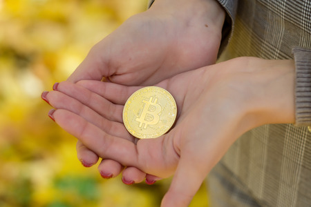 Crypto foreign currency. Business lady keeps bitcoin.の写真素材