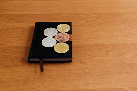 Coins of electronic money are on a notebook. Devaluation of e-currencies.の写真素材