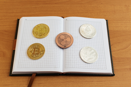 The background e-money lies on a notebook. bitcoin other coins.の写真素材