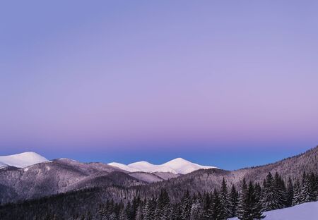 Winter morning view of snowy mountain peaks. Twilight before dawn.の写真素材