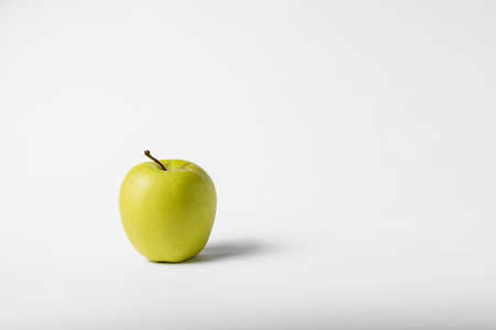 Green and yellow apple on a white backgroundの写真素材