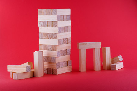 Wooden brick bars on a red background from the board gameの写真素材