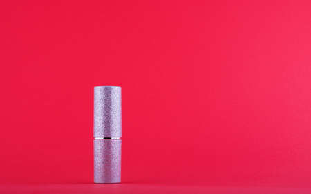 Silver lipstick matte on red background side viewの写真素材