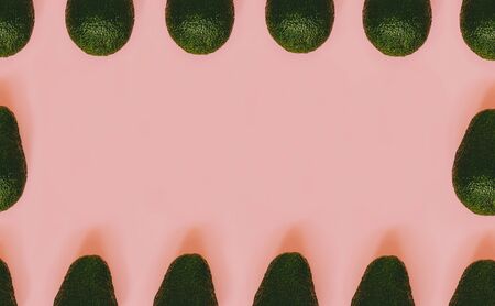 Frame from avocado on a pink background. Pop art design. Place for your text