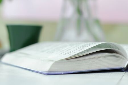 Book close-up, cup and vase. The concept of home schoolingの写真素材