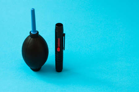 Portable kit for cleaning the camera lens close-up on a blue background.の写真素材