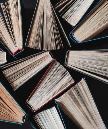 Parted books next to each other top view. Background from multicolored old books.の写真素材