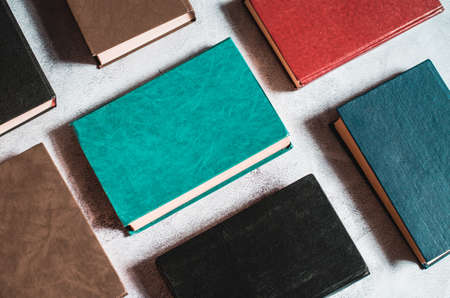 Books next to each other top view. Background from multicolored old books.の写真素材