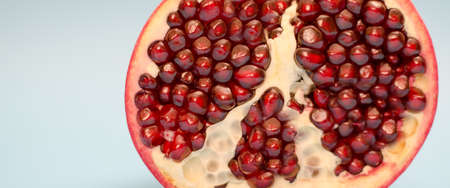 Half pomegranate on a blue background Close-upの写真素材