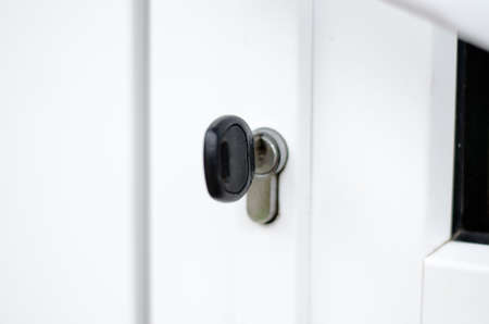 The key is in the door lock of the white front doorの写真素材