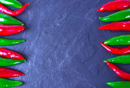 Red and green chili peppers on a stone background. Place for text. Over viewの写真素材