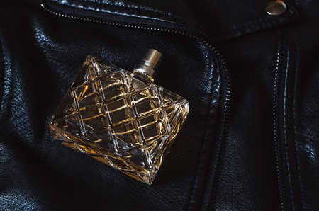 a bottle of women's perfume on a black leather jacket.の写真素材