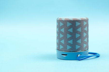 Portable wi-fi speaker. Musical column on a blue backgroundの写真素材
