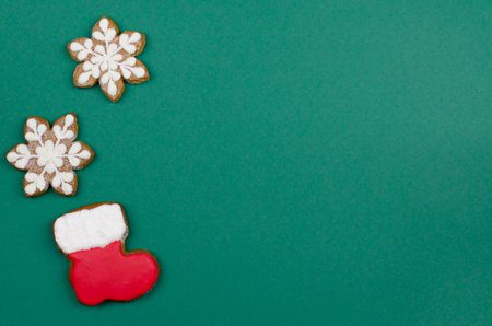 Santa Claus boots and snowflakes on a green background. Christmas gingerbread in the form of boots and snowflakesの写真素材