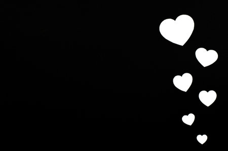 Paper hearts on a black background. Valentine's day background.の写真素材